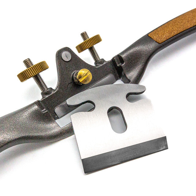 The Melbourne Tool Company Spokeshave, a sleek metal tool with an adjustable blade and twin brass screws, elegantly rests on a white background. Ideal for woodworking enthusiasts who value precision and quality craftsmanship.