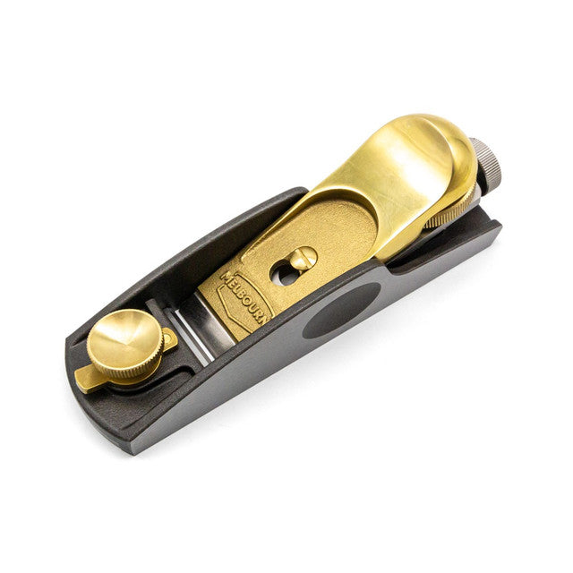 The Low Angle Block Plane by Melbourne Tool Company features brass and steel construction, an M2 High Speed Steel blade, and precision adjustment knobs, making it ideal for woodworking.