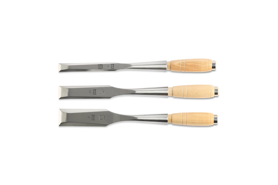 The MHG Messerschmidt Timber Framing Chisels, featuring metal blades and wooden handles for superior edge retention, are perfectly aligned horizontally on a white background—ideal for professional woodworkers pursuing precision.