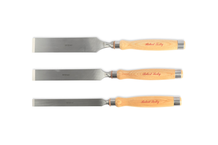 The Robert Sorby Registered Timber Framing Chisels from SOR feature three wood handles, each engraved with a name and metal square edge blades. Perfect for deep mortising tasks, these chisels are aligned horizontally against a plain white background.