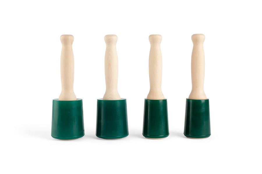 Four MID Wood Is Good Mallets, with ergonomic hardwood handles and urethane heads, stand upright on a white background.