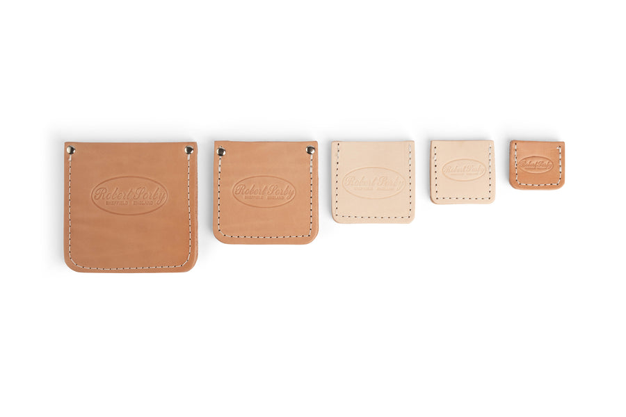 Five Robert Sorby Leather Edge Guards by SOR, ranging from large to small, feature stitched edges and embossed branding. Perfect for organizing woodworking tools or as protective pouches.