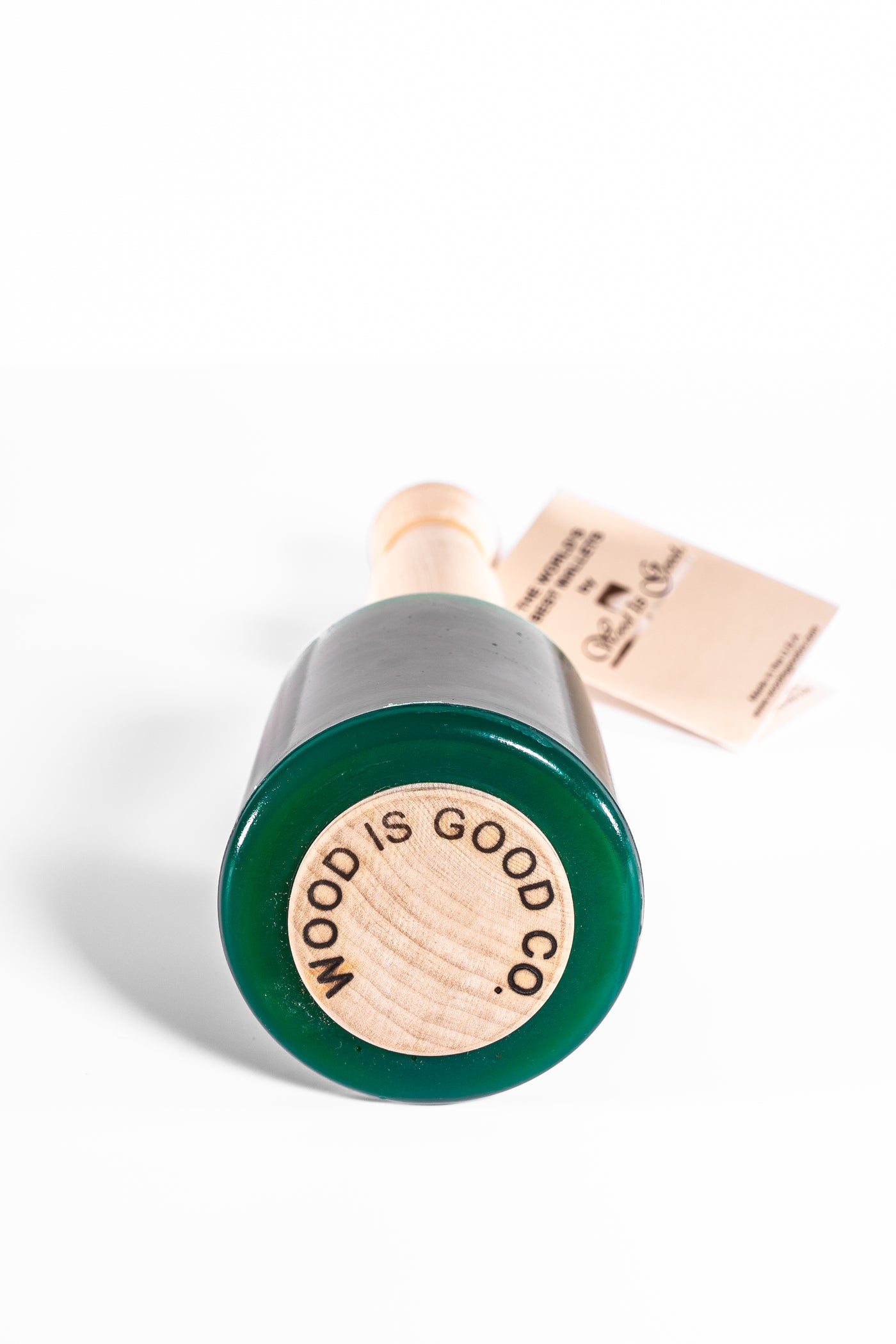 The Wood Is Good Mallet by MID has a green urethane head and an ergonomic light wood handle, with "Wood Is Good Co." proudly branded on the base, all set against a white background.