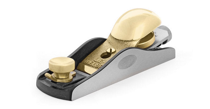 The Lie-Nielsen 60-1/2-in Adjustable Mouth Block Plane is a high-quality metal hand plane featuring a gold-colored cap, adjustment knob, and iron, expertly designed for fine woodworking projects.