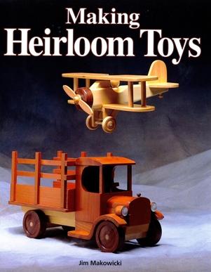 Cover of "Making Heirloom Toys" from Taunton Press by Jim Makowicki, featuring wooden toy models of an airplane and a vintage truck that showcase charming transportation toys.