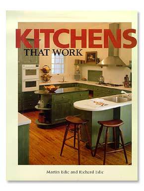 The cover of the book "Kitchens that Work" by Shelter Institute showcases a cozy kitchen featuring green cabinets, a wooden floor, an island, and stools. The book includes expert insights on cabinetry installation and design layout by authors Martin Edic and Richard Edic.