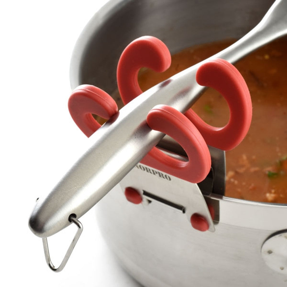 The NORP Grip-Ez Pot Clip is a stainless steel pot with red silicone handles and a ladle holder, containing soup with visible herbs and vegetables.