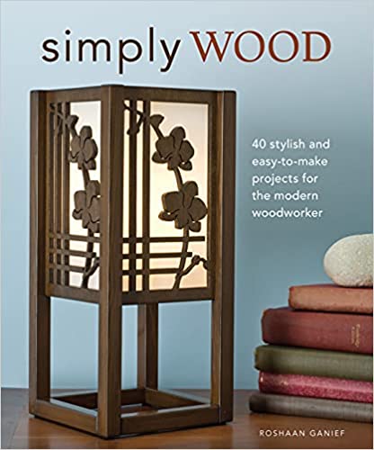 Cover of the book "Simply Wood: 40 Stylish and Easy-To-Make Projects for the Modern Woodworker" by Roshaan Ganief, featuring a decorative wooden lamp and text about various scroll saw projects for enhancing home décor, published by FOX.